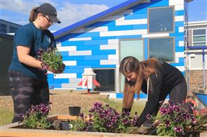 students planting flowers