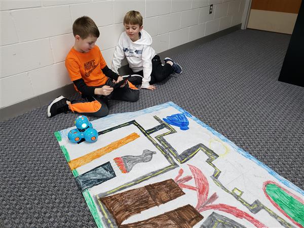 Coding using Dash robots and maps they created in homeroom