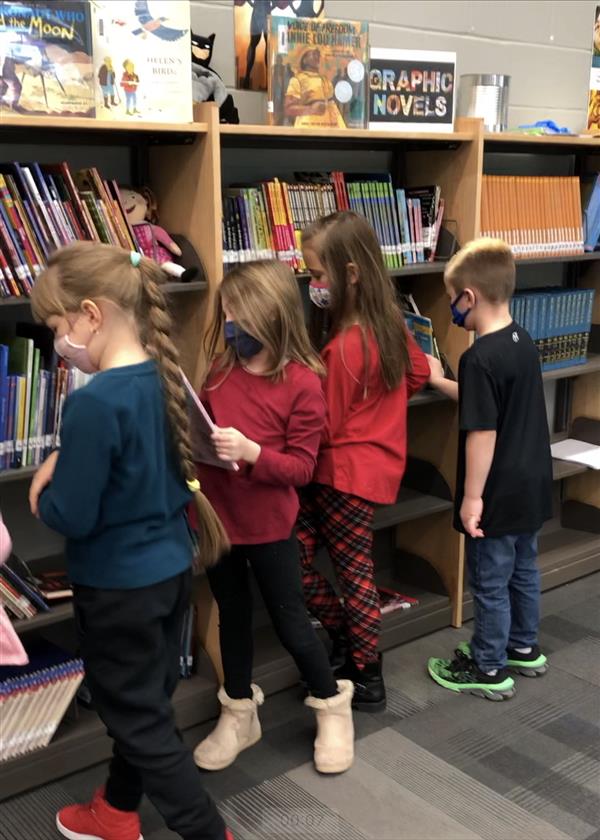 Students picking out library books
