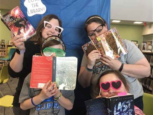 Students holding favorite books